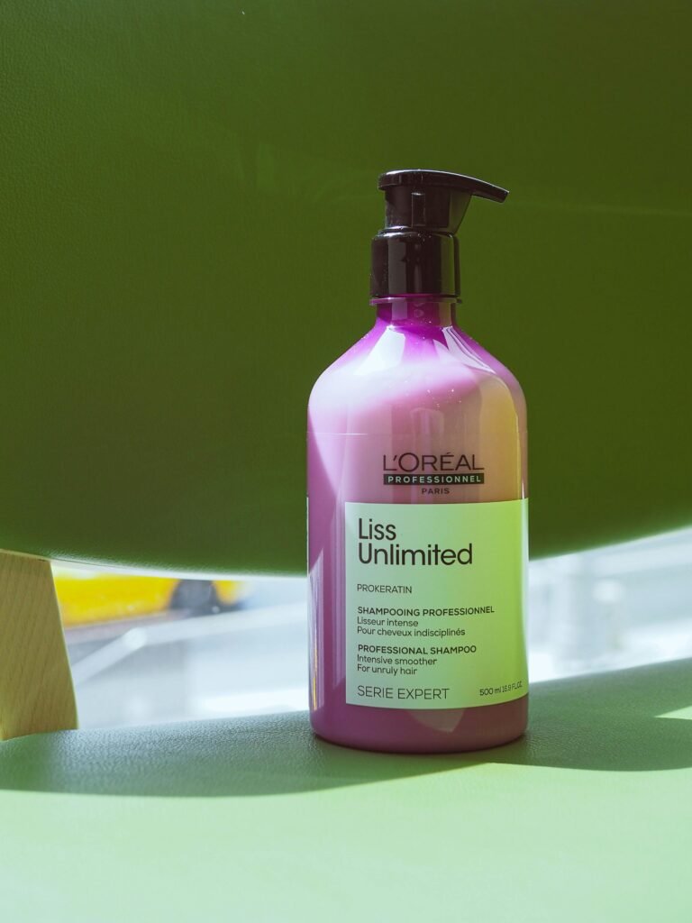 Close-up of L'Oreal Liss Unlimited shampoo in natural lighting, ideal for hair care visuals.